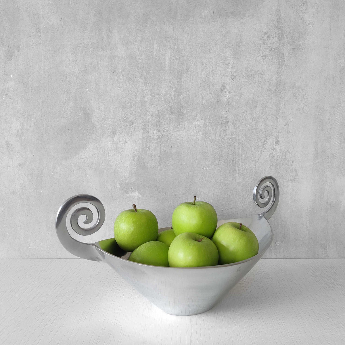 A 1990s cast aluminium centrepiece bowl with spiral handles