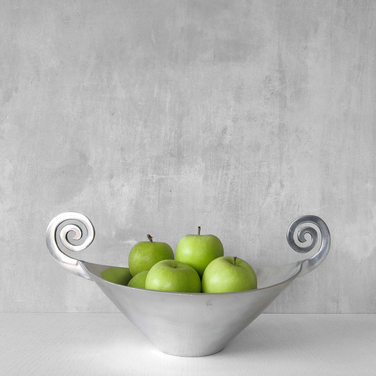 A 1990s cast aluminium centrepiece bowl with spiral handles