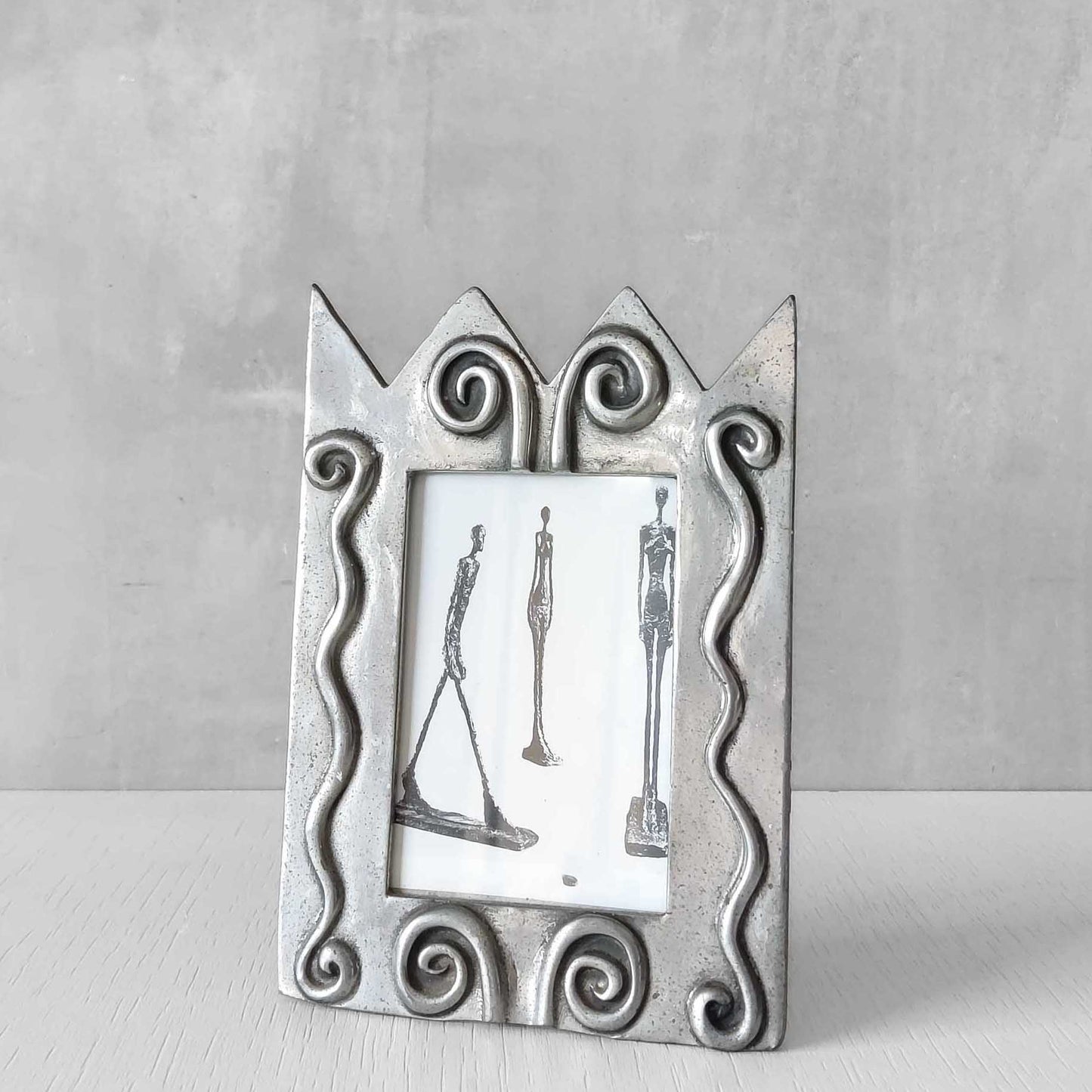 An early 1990s Carrol Boyes sculptural cast pewter photo frame with scroll reliefs