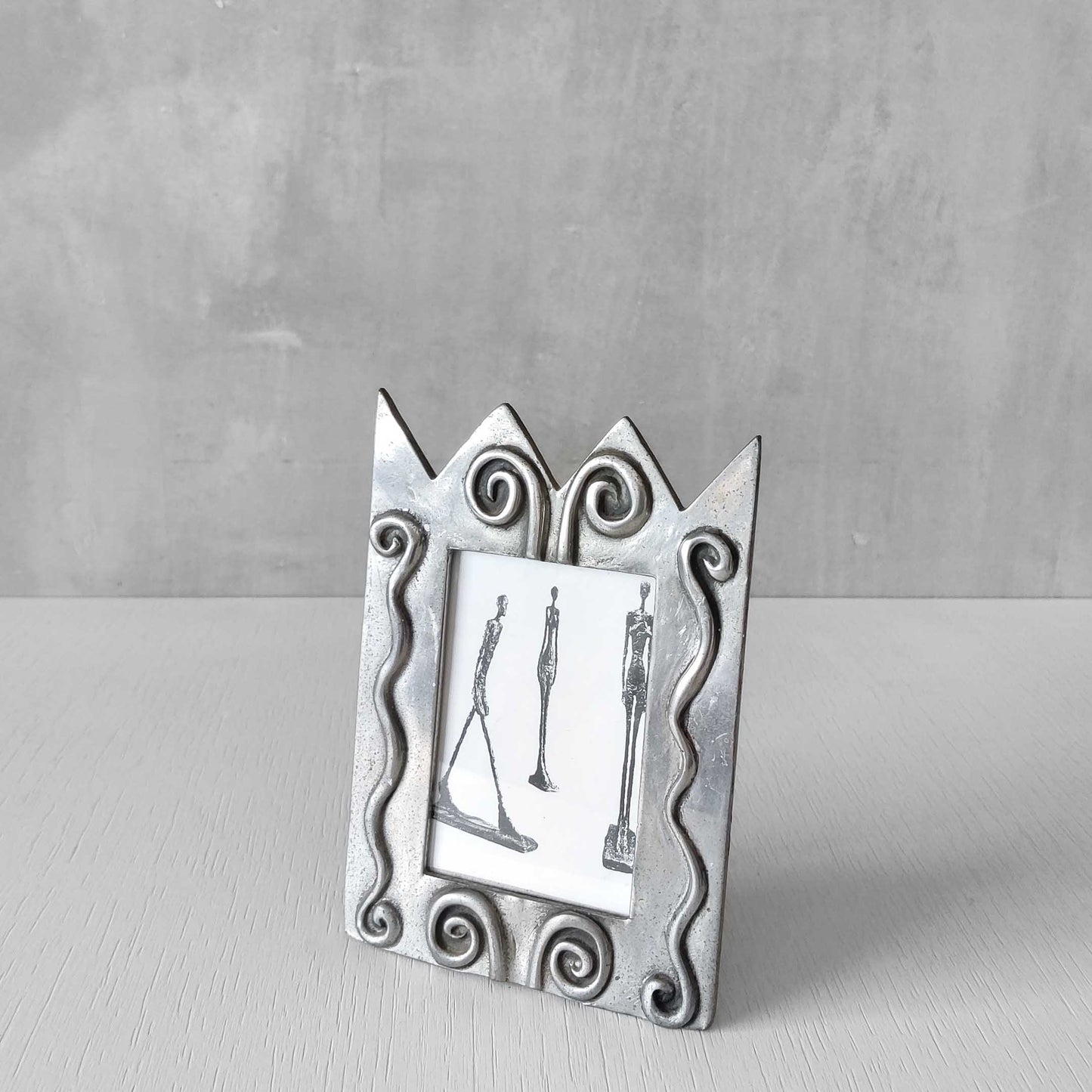 An early 1990s Carrol Boyes sculptural cast pewter photo frame with scroll reliefs