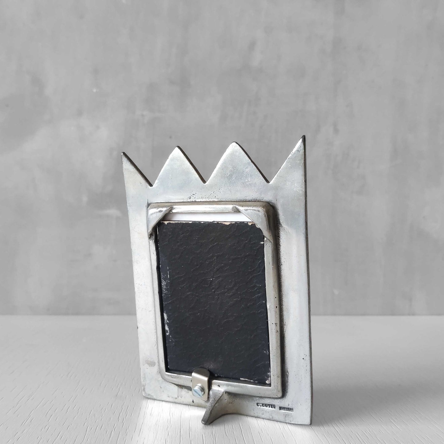 An early 1990s Carrol Boyes sculptural cast pewter photo frame with scroll reliefs