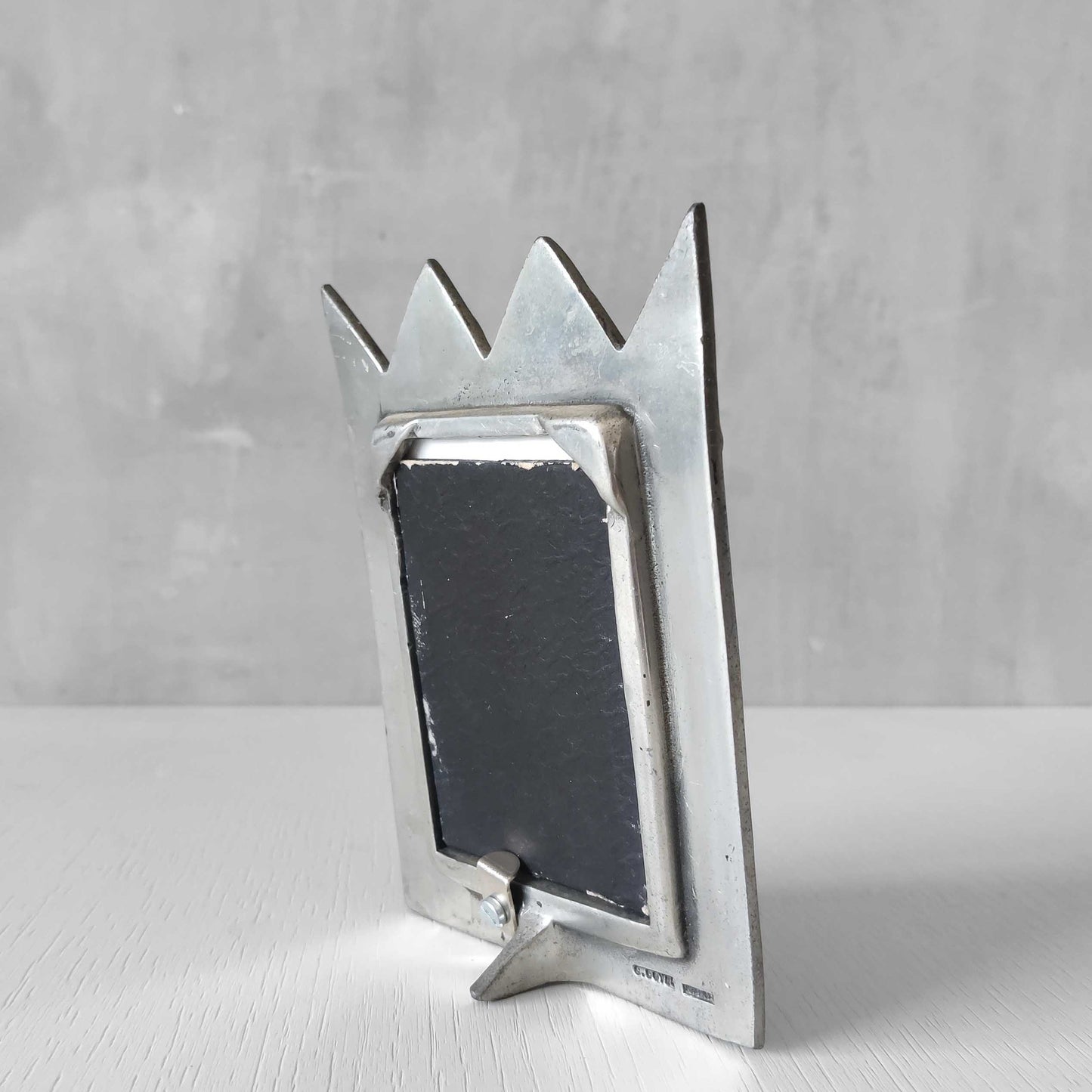 An early 1990s Carrol Boyes sculptural cast pewter photo frame with scroll reliefs