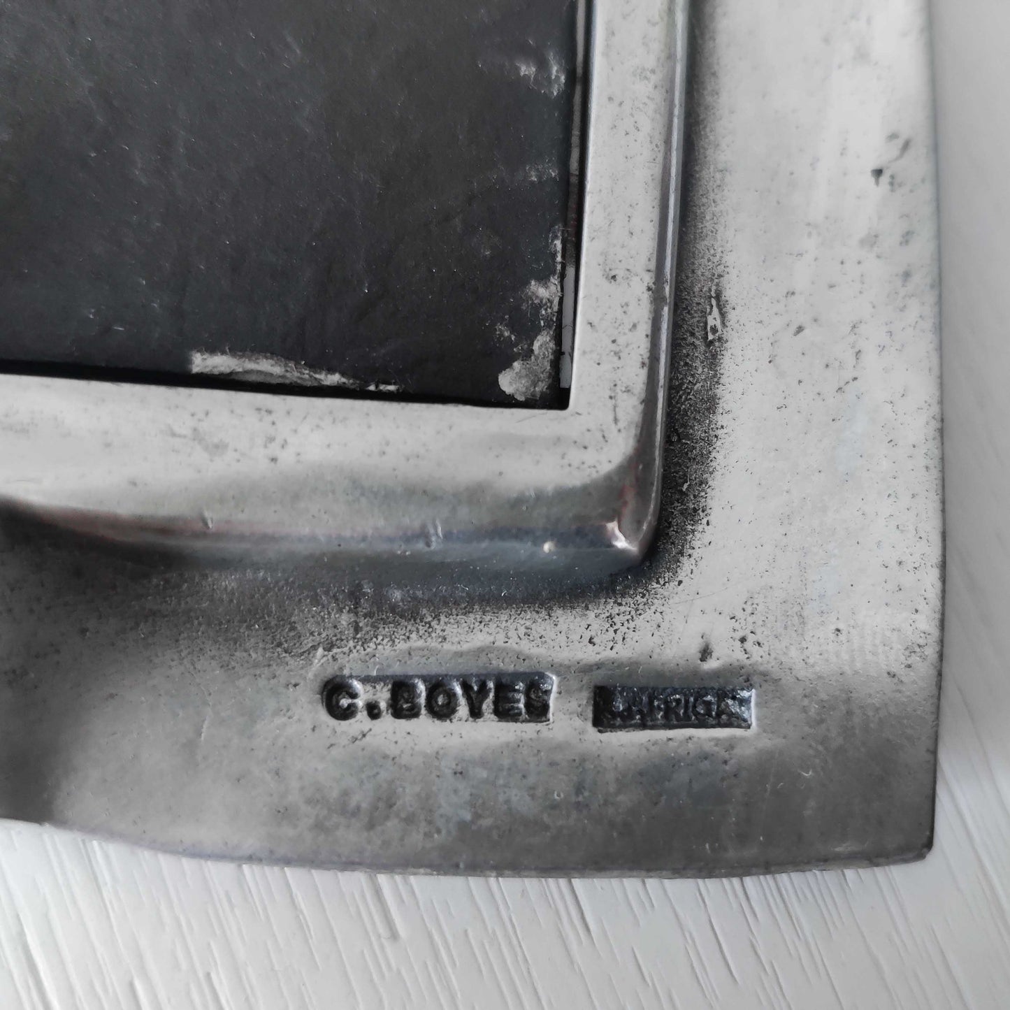 An early 1990s Carrol Boyes sculptural cast pewter photo frame with scroll reliefs
