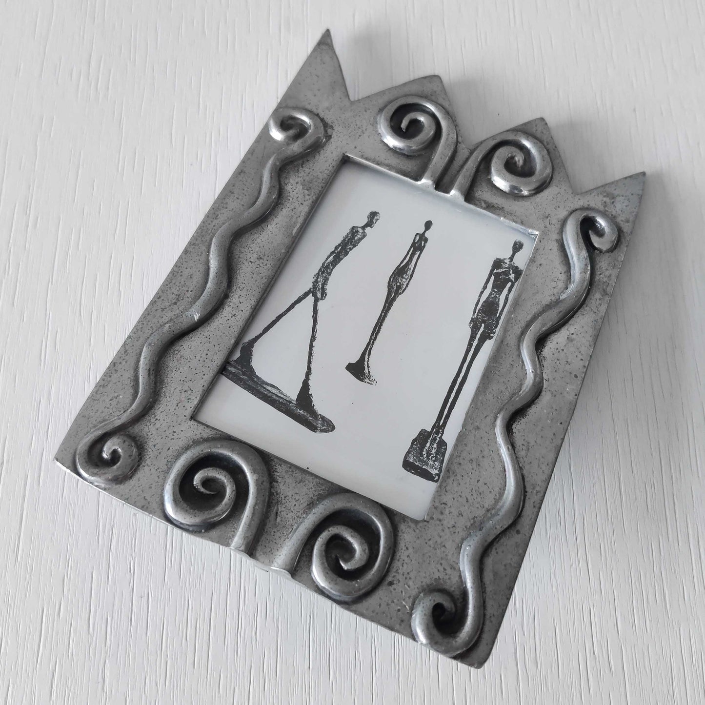 An early 1990s Carrol Boyes sculptural cast pewter photo frame with scroll reliefs