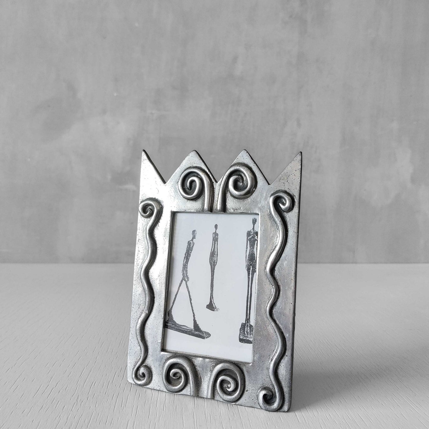 An early 1990s Carrol Boyes sculptural cast pewter photo frame with scroll reliefs