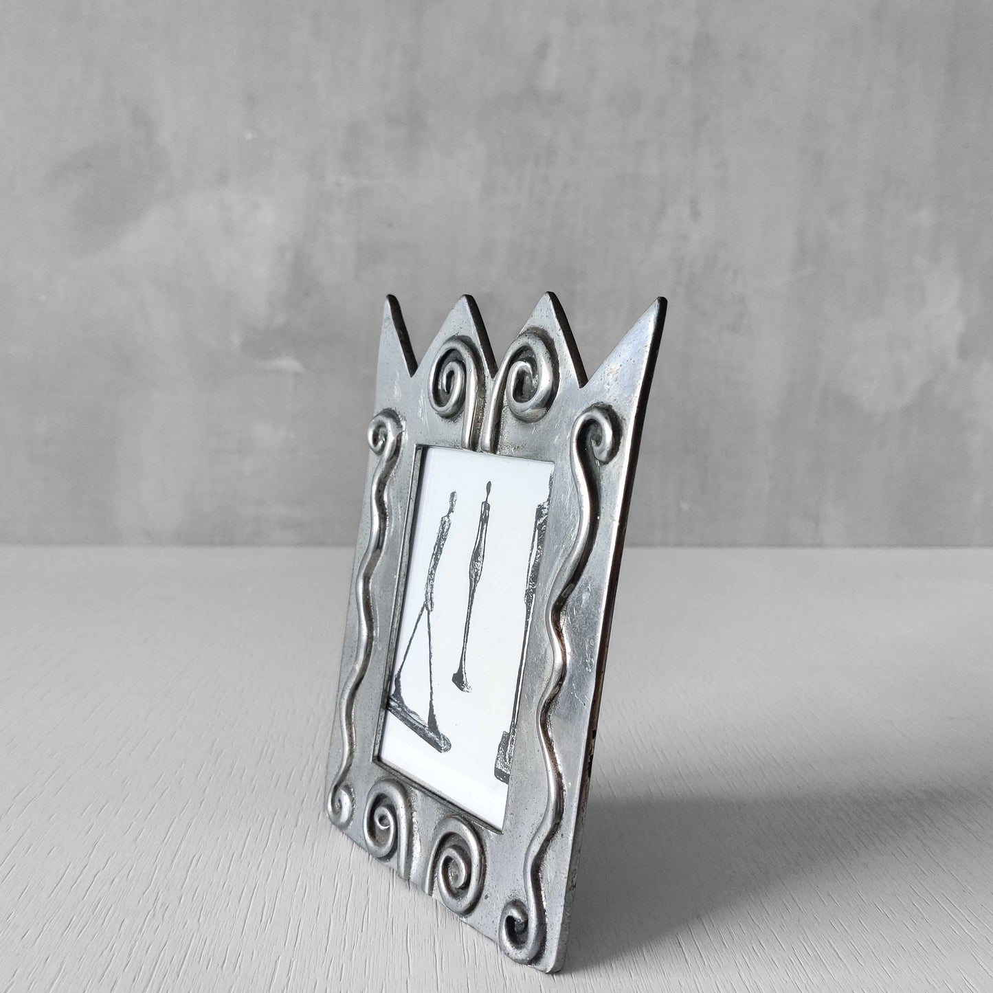 An early 1990s Carrol Boyes sculptural cast pewter photo frame with scroll reliefs