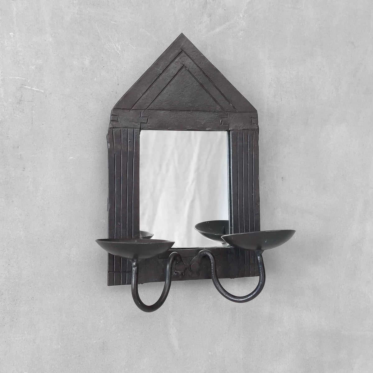 A small vintage architectural pedimented steel framed mirror candle sconce