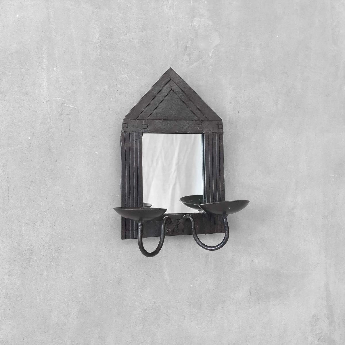 A small vintage architectural pedimented steel framed mirror candle sconce
