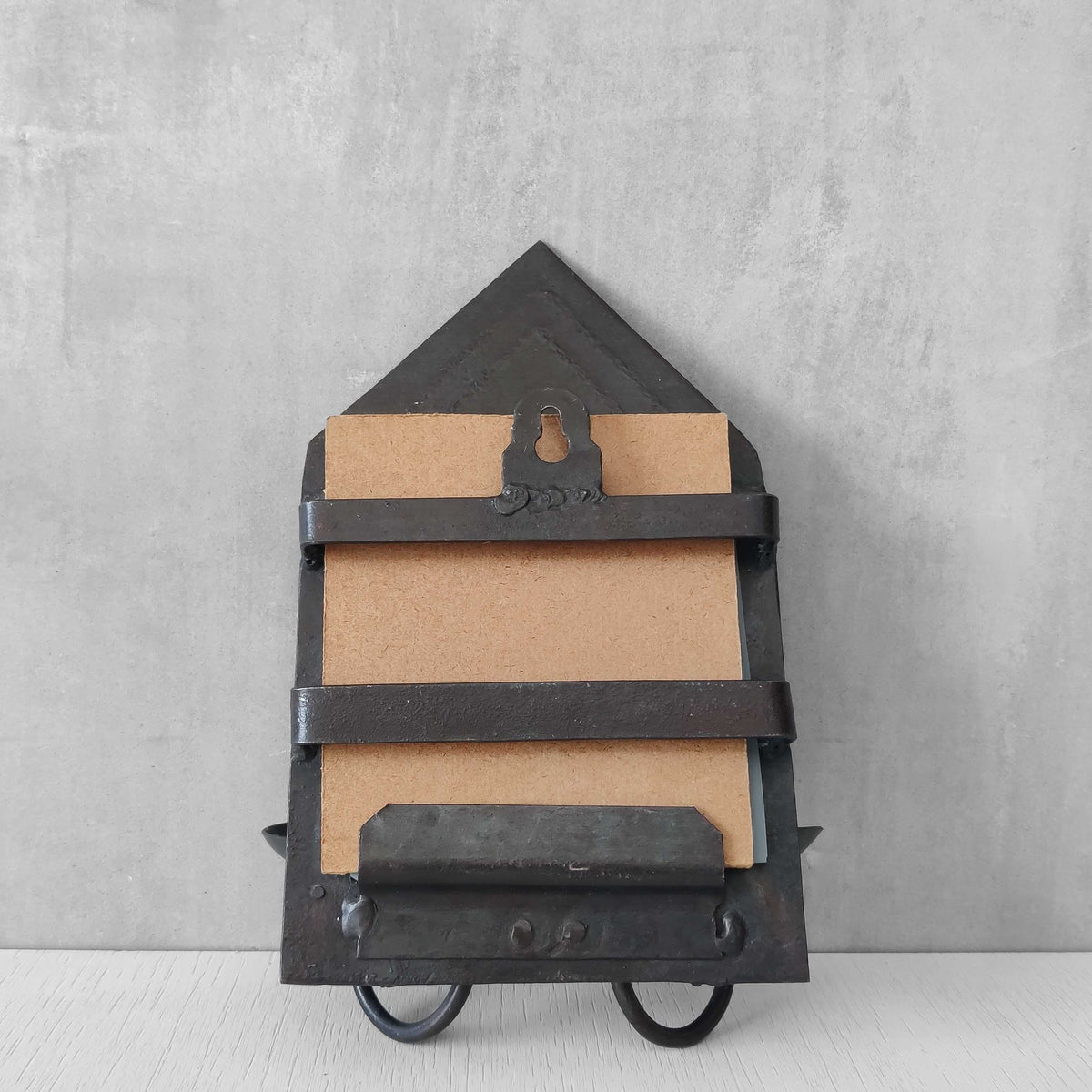 A small vintage architectural pedimented steel framed mirror candle sconce
