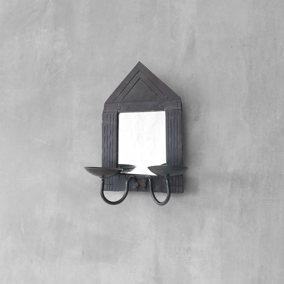 A small vintage architectural pedimented steel framed mirror candle sconce