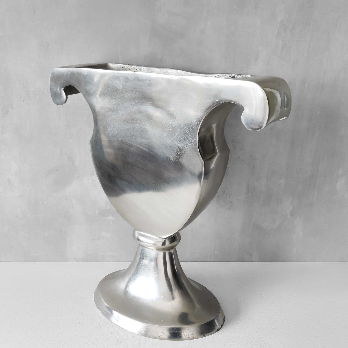 A vintage large cast aluminium sculptural urn profile vase