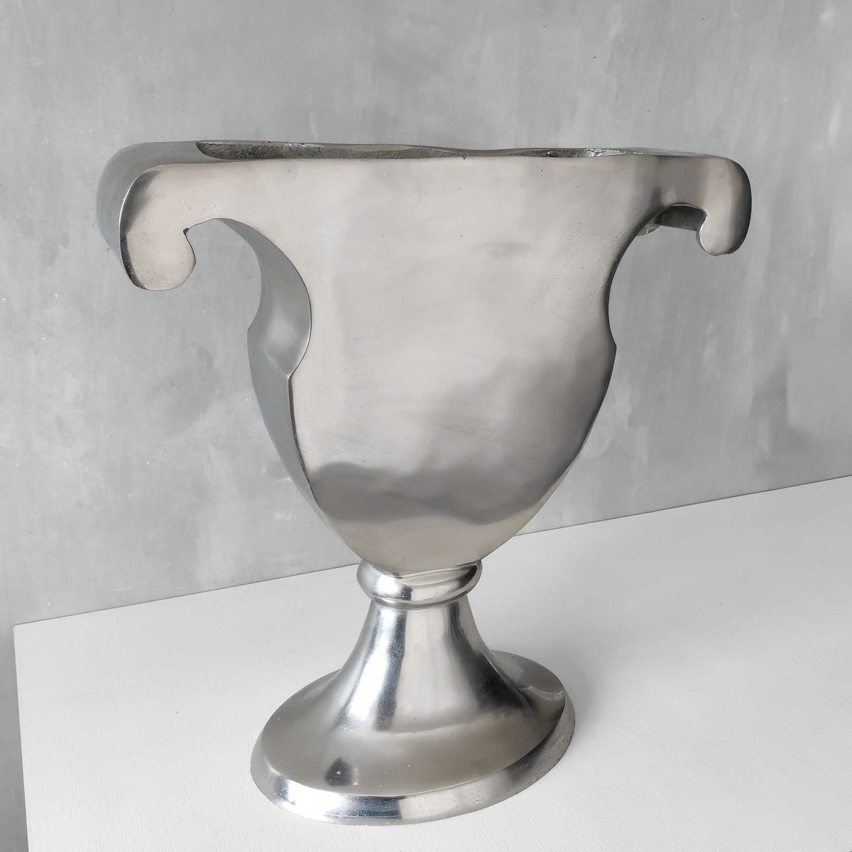 A vintage large cast aluminium sculptural urn profile vase