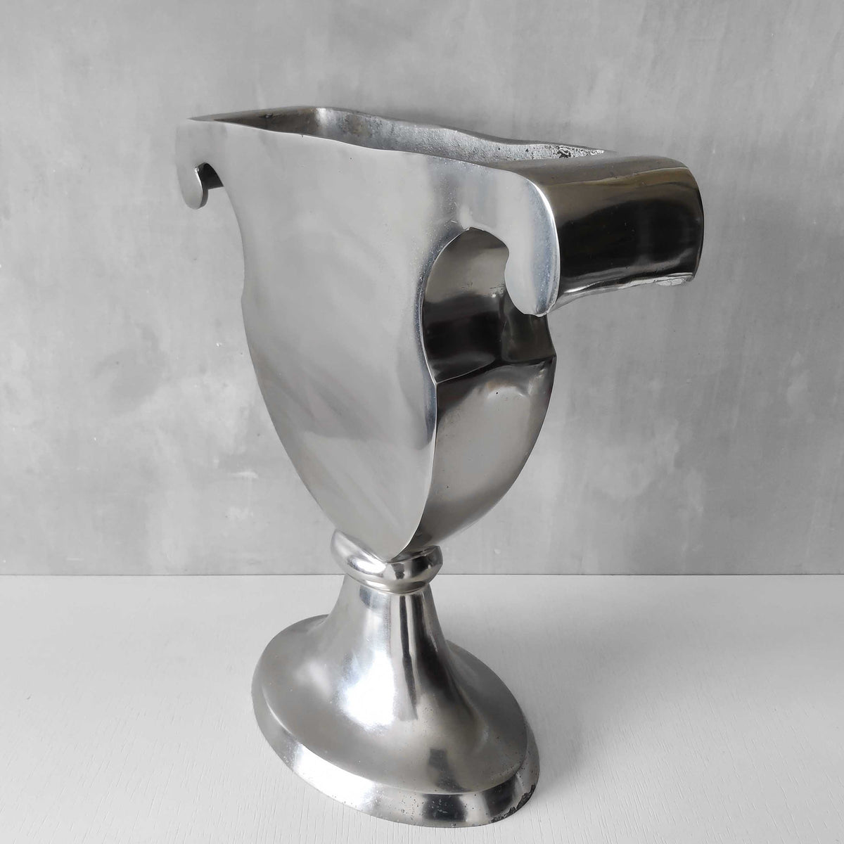 A vintage large cast aluminium sculptural urn profile vase