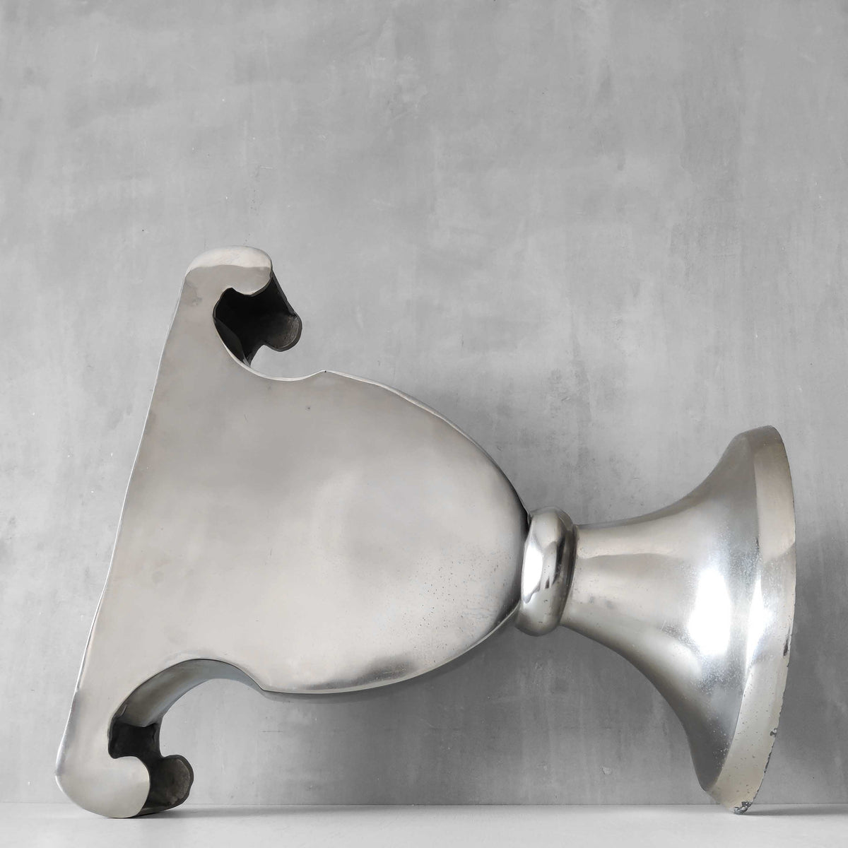 A vintage large cast aluminium sculptural urn profile vase