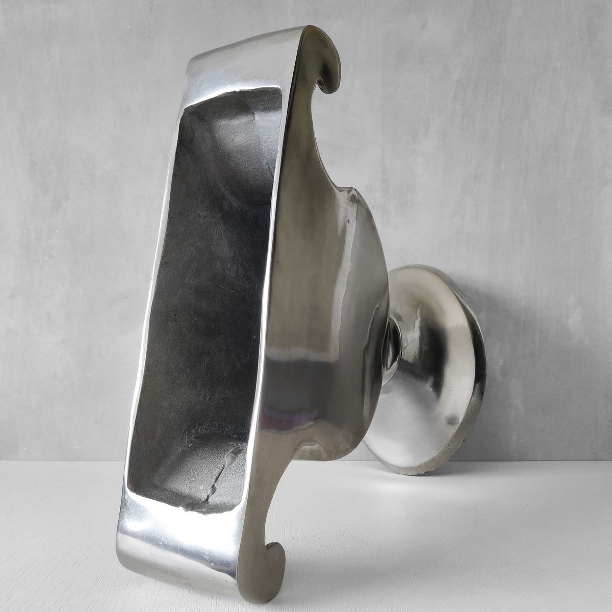 A vintage large cast aluminium sculptural urn profile vase