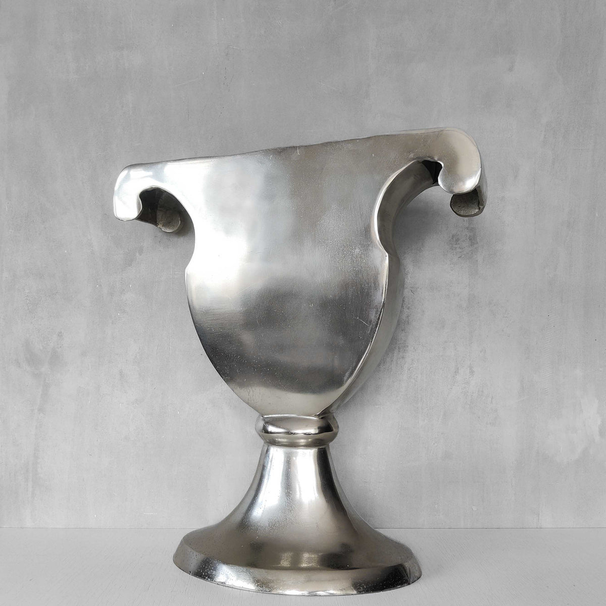 A vintage large cast aluminium sculptural urn profile vase