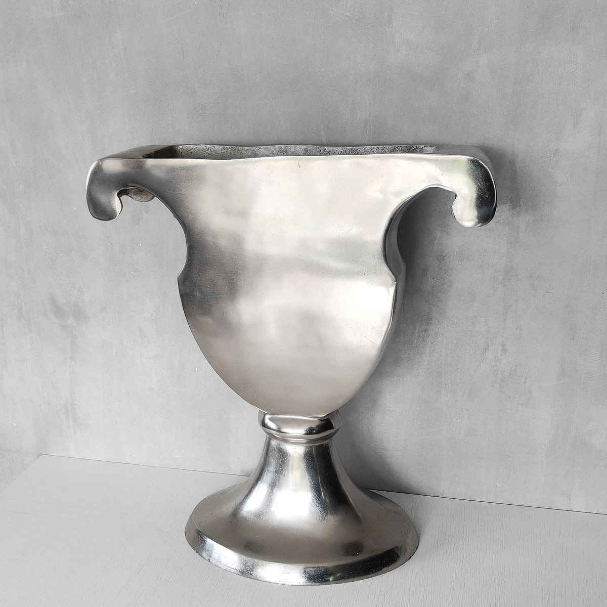 A vintage large cast aluminium sculptural urn profile vase