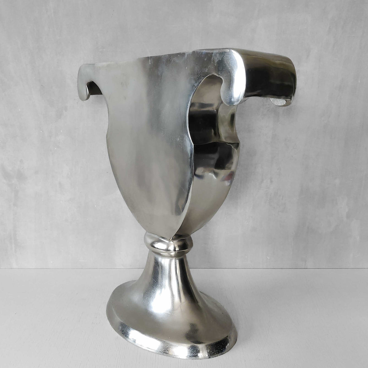 A vintage large cast aluminium sculptural urn profile vase