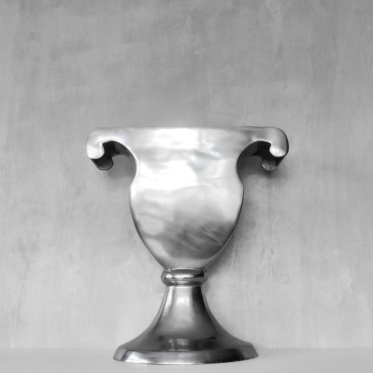A vintage large cast aluminium sculptural urn profile vase