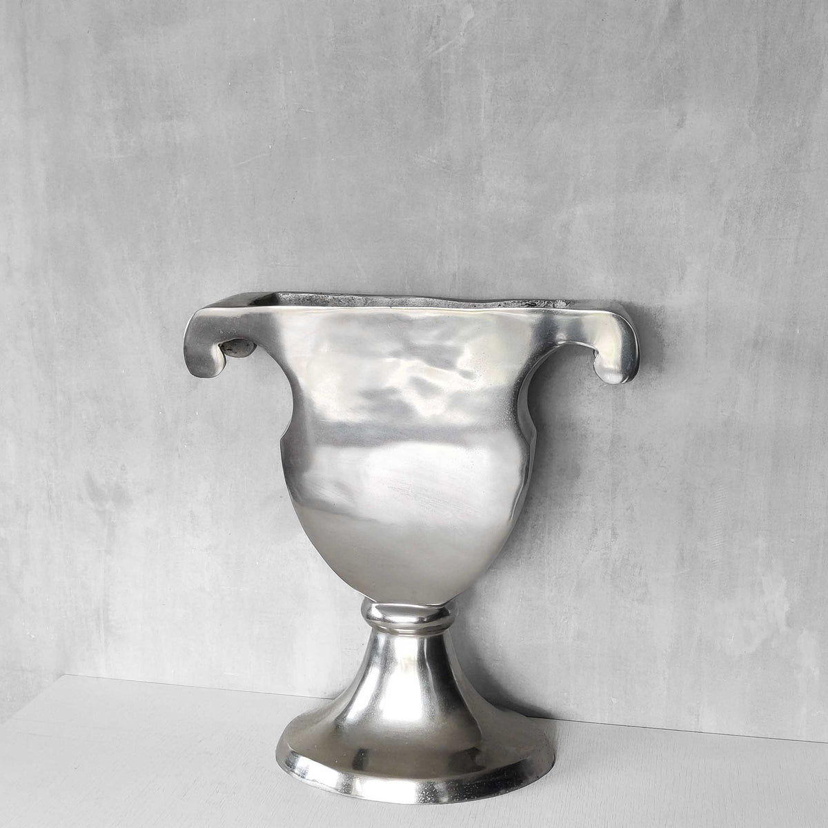 A vintage large cast aluminium sculptural urn profile vase