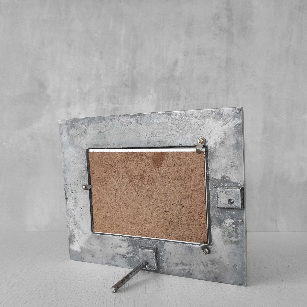 A vintage hand sand cast aluminium photo frame with gecko motifs