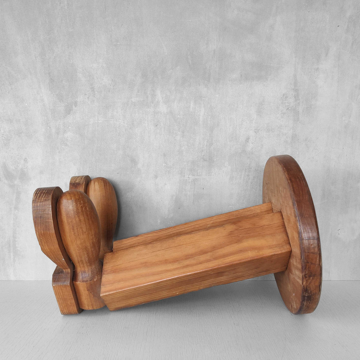 A 1980s postmodern pop art revival pine stool or plinth with booted feet