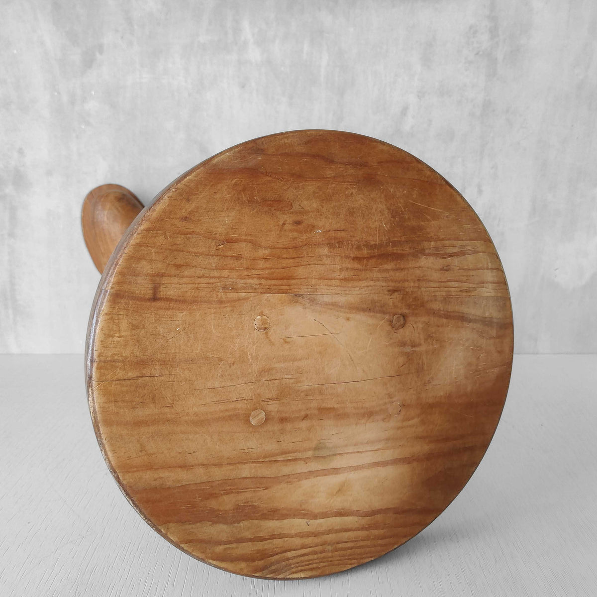 A 1980s postmodern pop art revival pine stool or plinth with booted feet