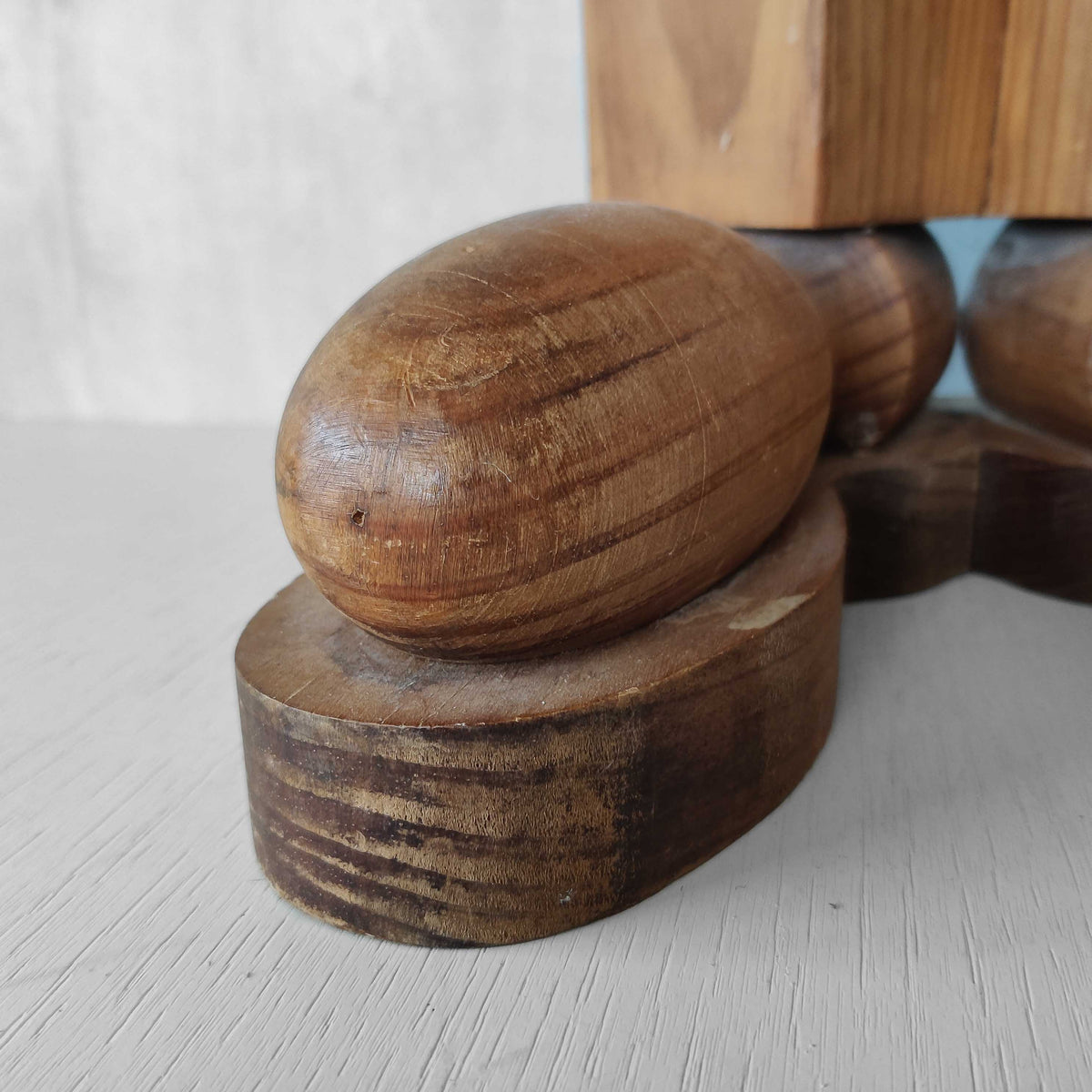 A 1980s postmodern pop art revival pine stool or plinth with booted feet