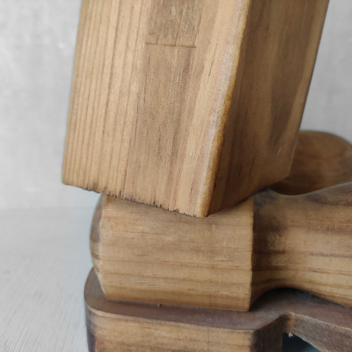 A 1980s postmodern pop art revival pine stool or plinth with booted feet