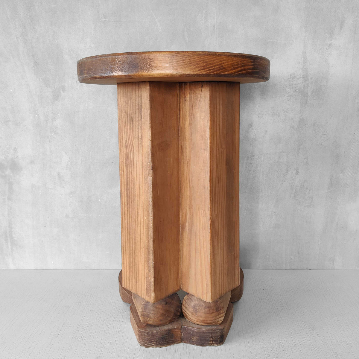 A 1980s postmodern pop art revival pine stool or plinth with booted feet