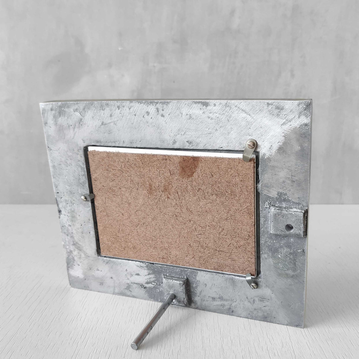 A vintage hand sand cast aluminium photo frame with gecko motifs