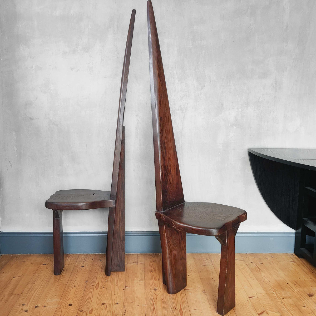 A pair of brutalist sculptural obelisk high back elm chairs
