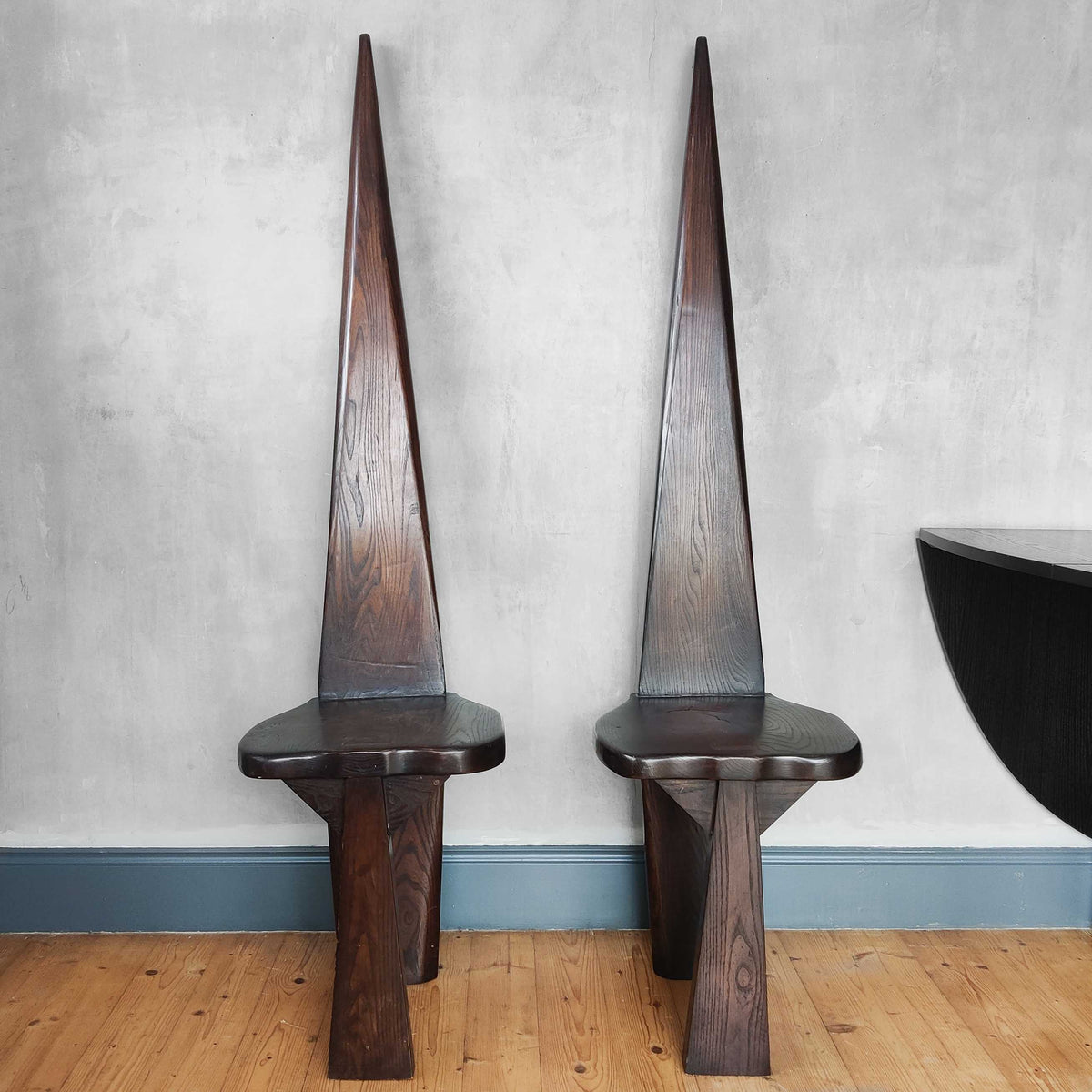 A pair of brutalist sculptural obelisk high back elm chairs