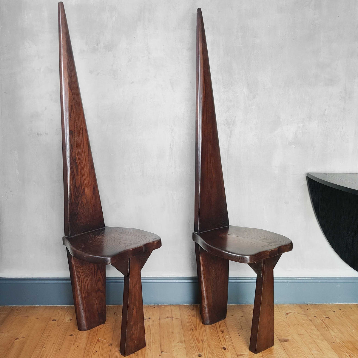 A pair of brutalist sculptural obelisk high back elm chairs