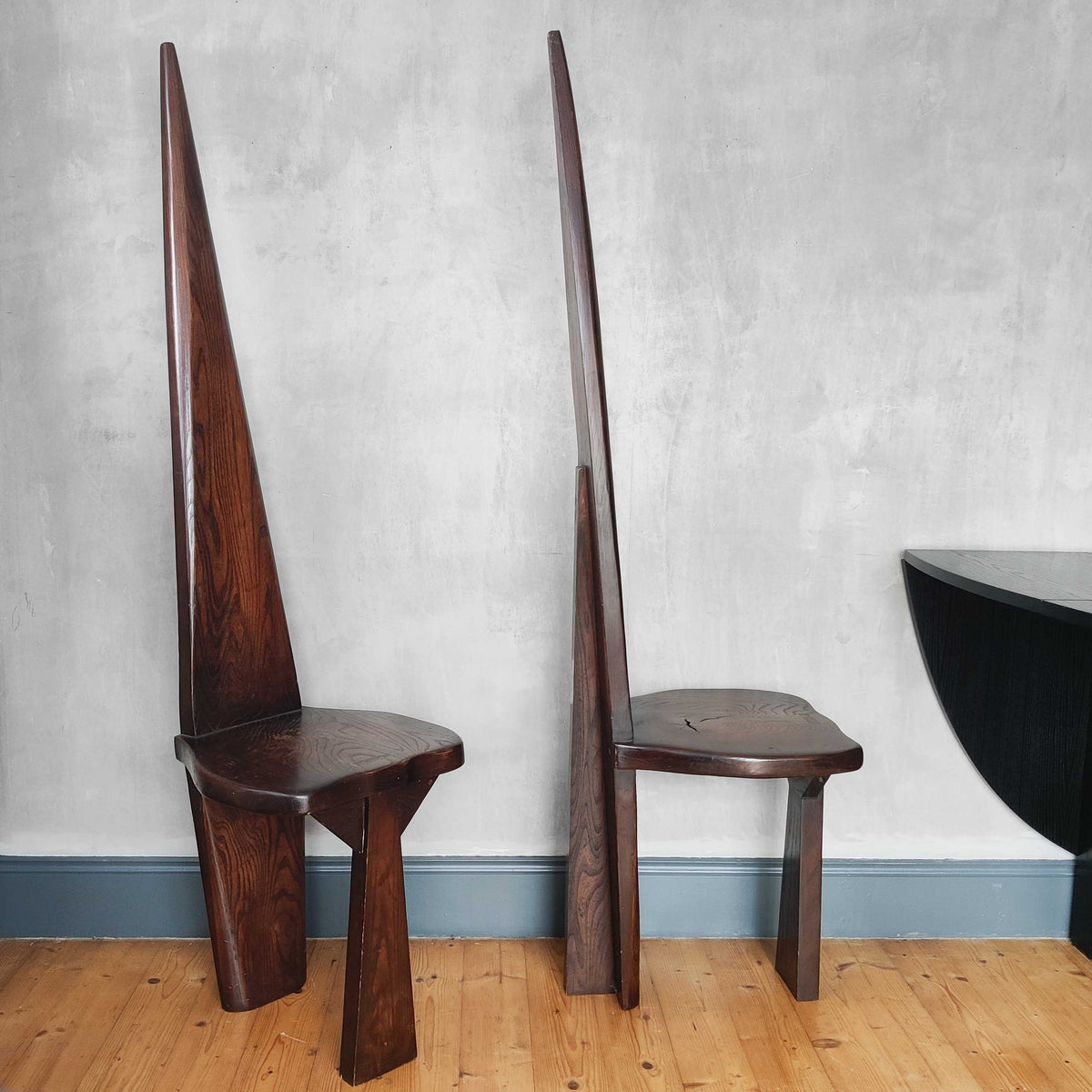 A pair of brutalist sculptural obelisk high back elm chairs