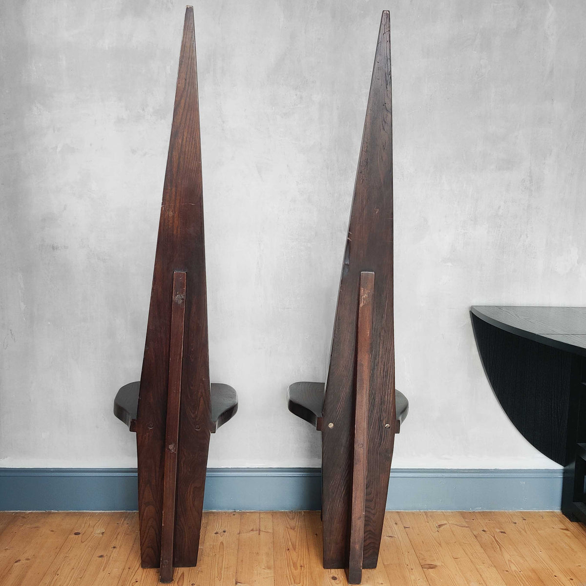 A pair of brutalist sculptural obelisk high back elm chairs