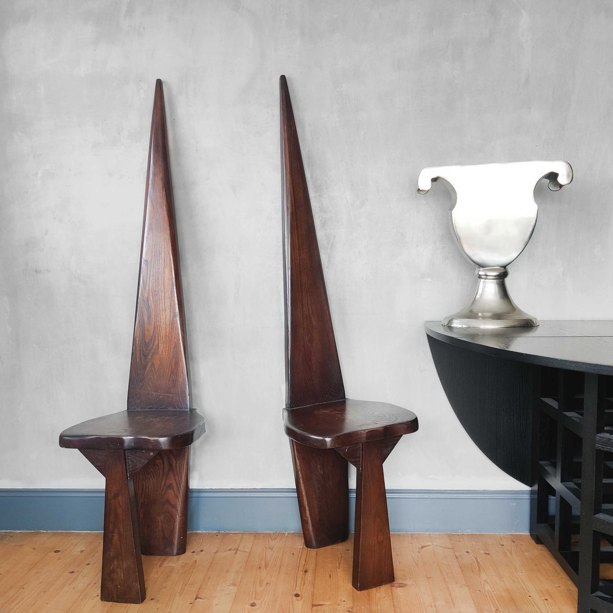 A pair of brutalist sculptural obelisk high back elm chairs