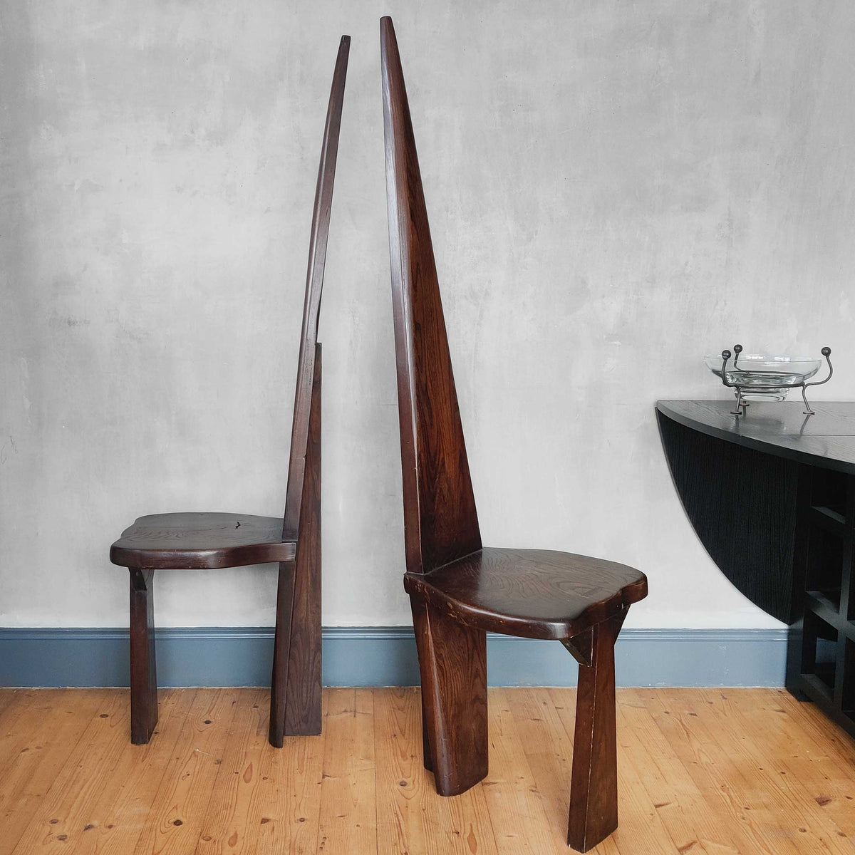 A pair of brutalist sculptural obelisk high back elm chairs