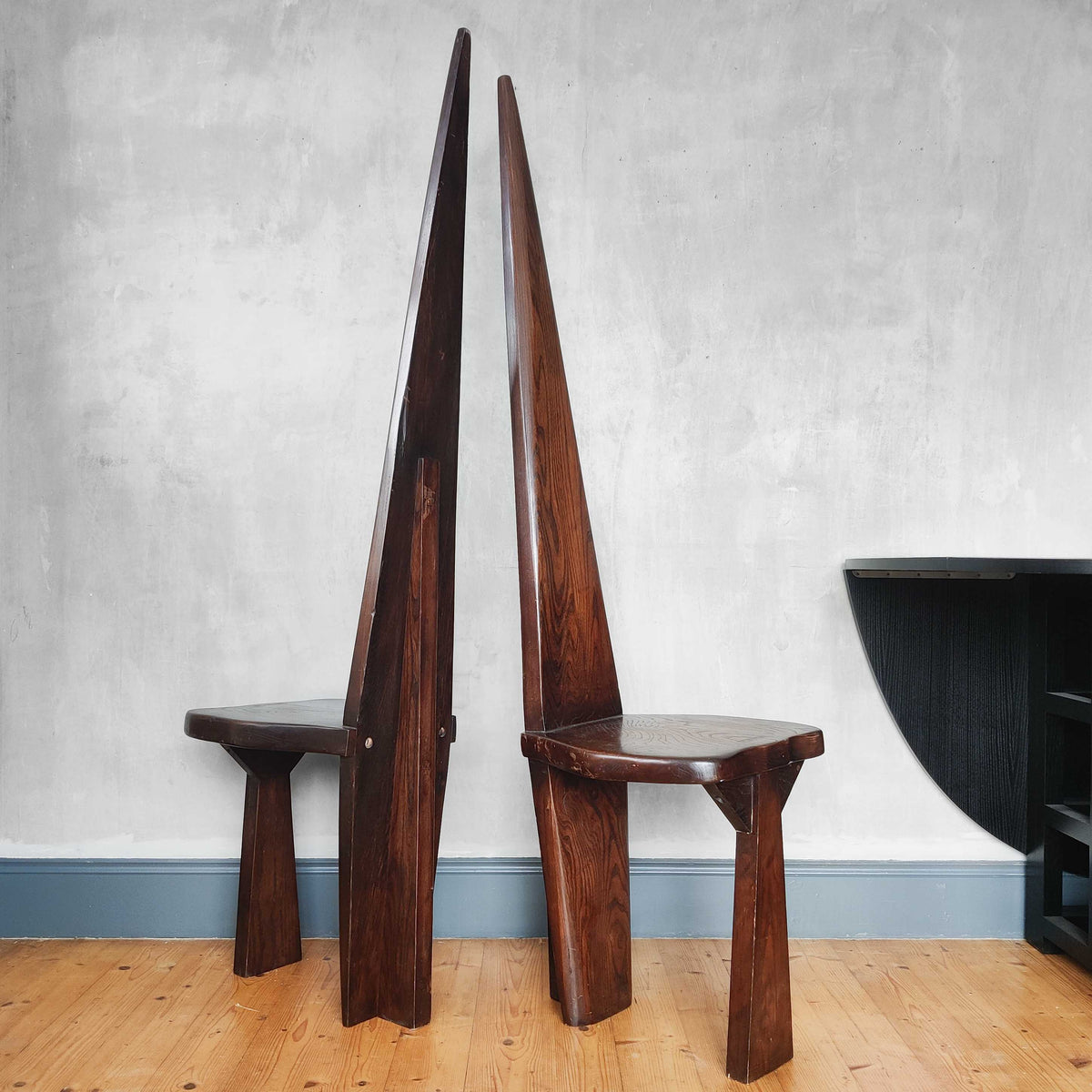 A pair of brutalist sculptural obelisk high back elm chairs
