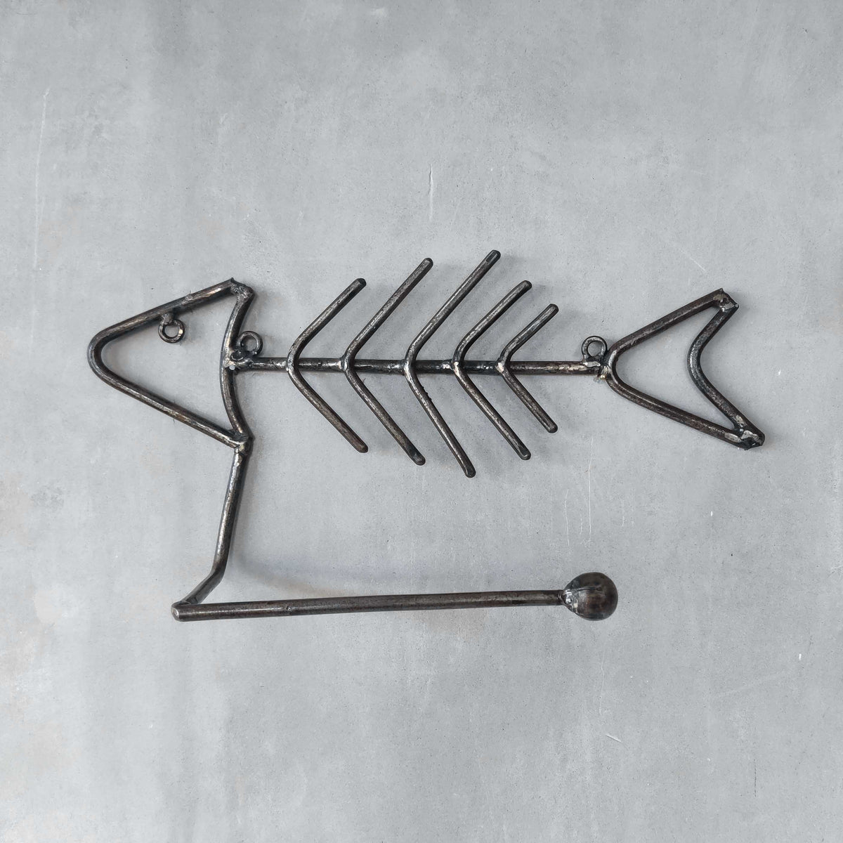Vintage artisan made metalwork welded steel fish skeleton toilet roll holder