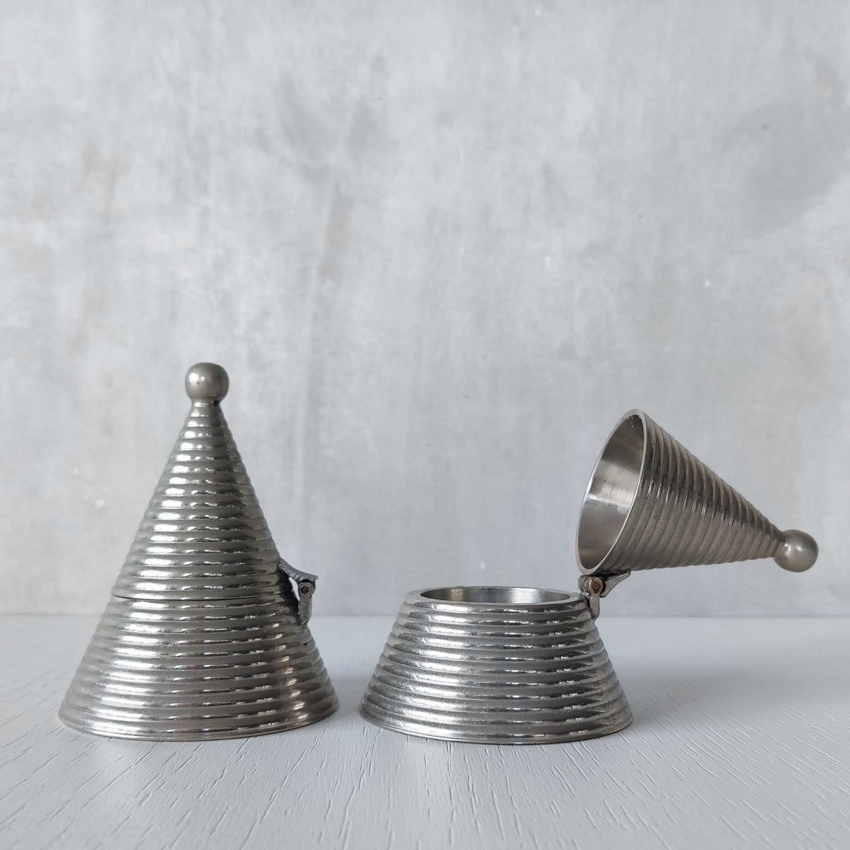 Pair of vintage conical ribbed cast metal tea light holders Aldo Rossi style