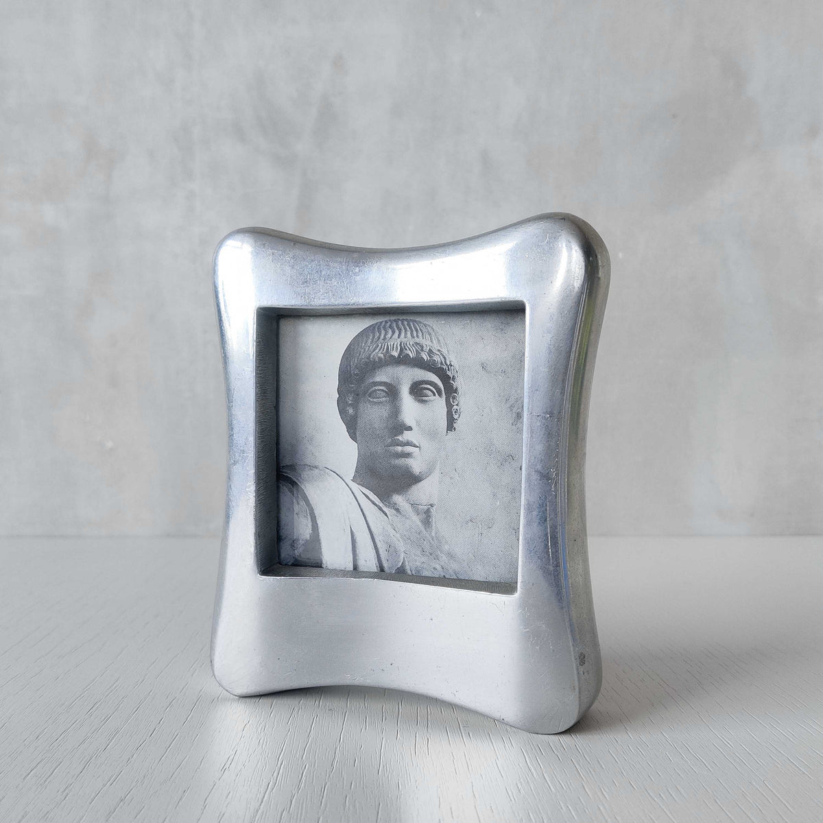 A 1990s chunky cast aluminium sculptural organic form photo frame