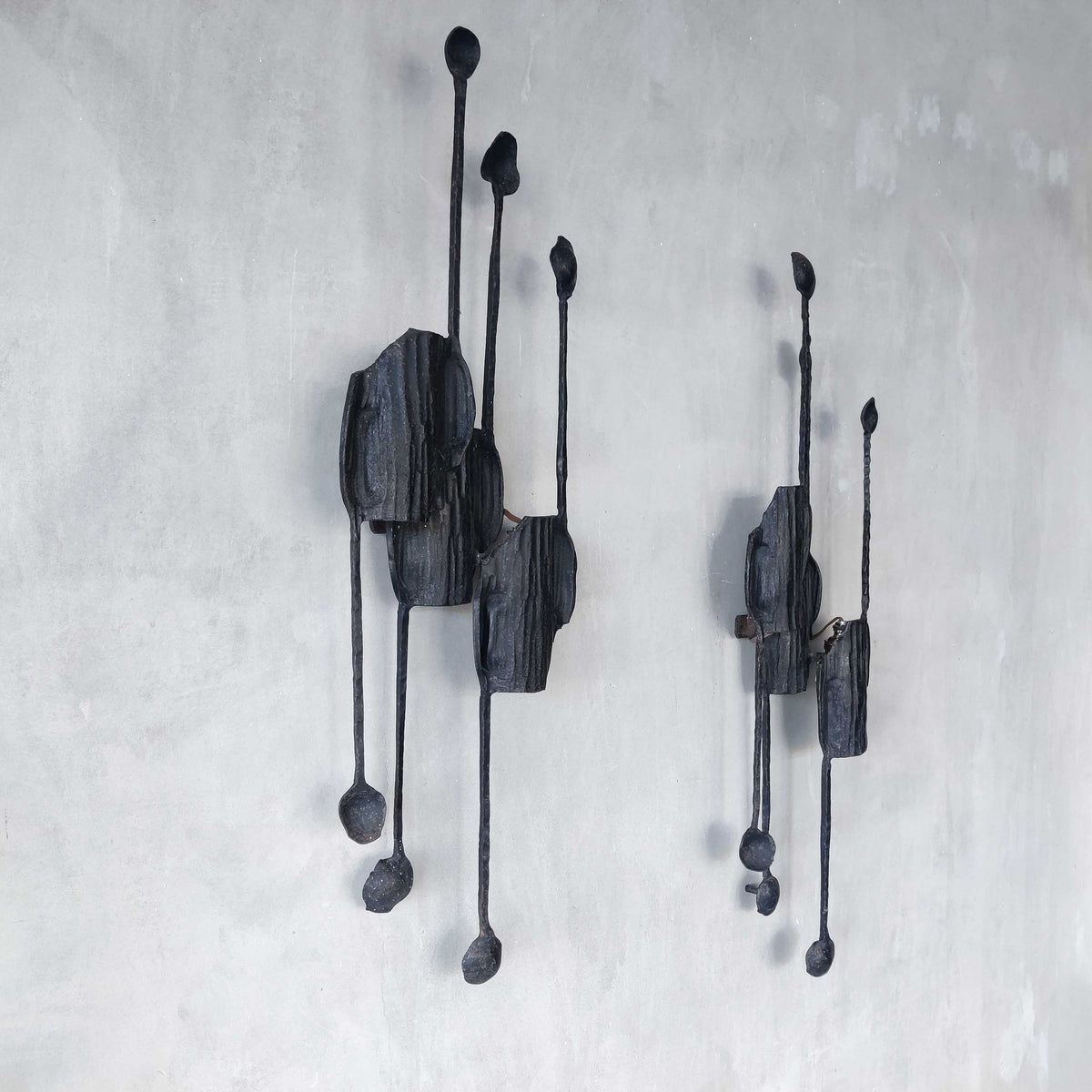 A pair of vintage Italian Brutalist sculptural wrought iron wall lights sconces