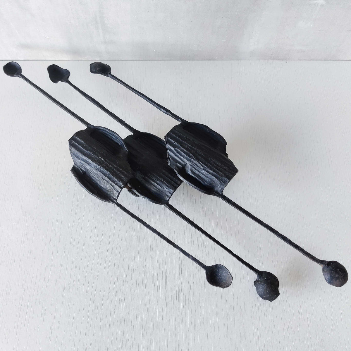 A pair of vintage Italian Brutalist sculptural wrought iron wall lights sconces