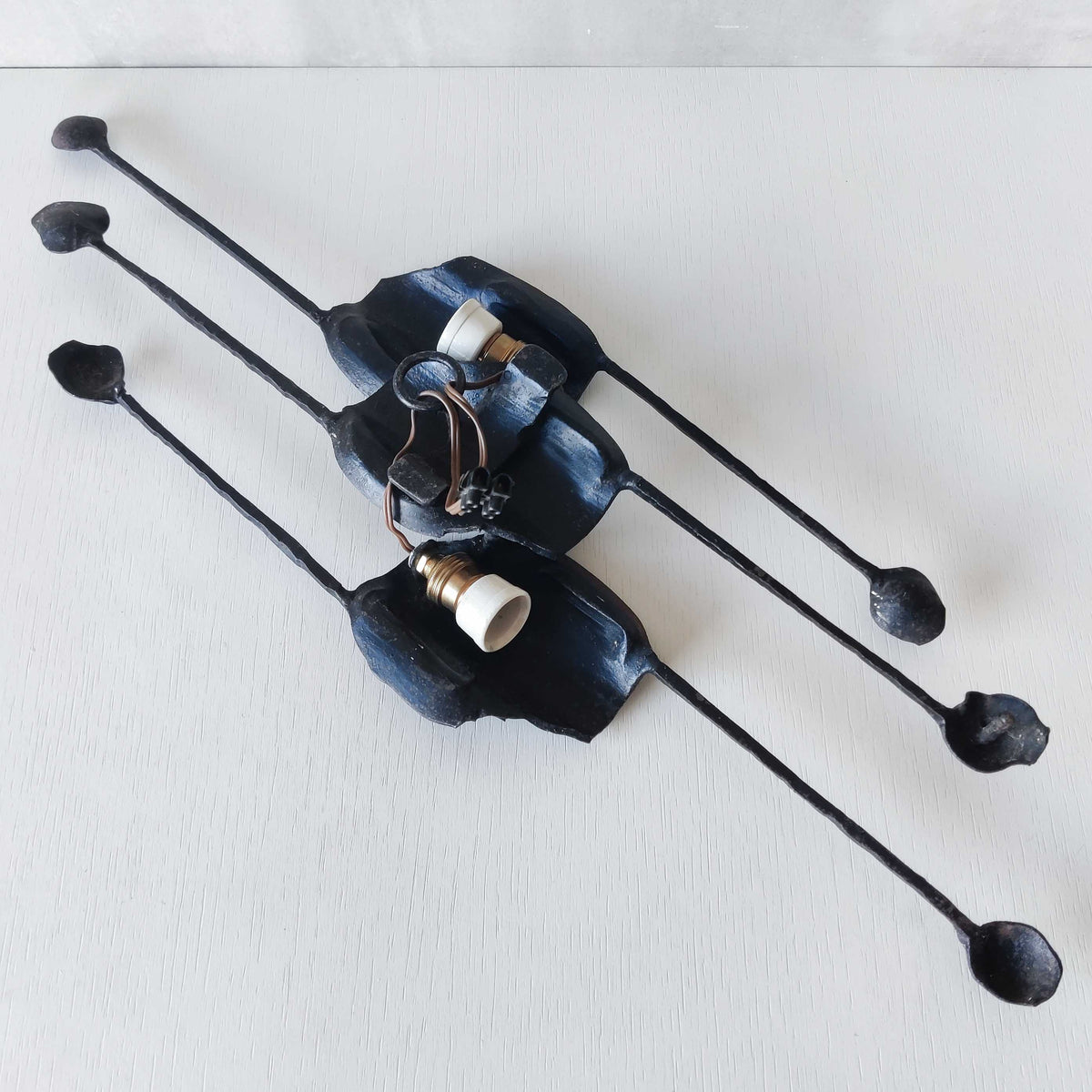 A pair of vintage Italian Brutalist sculptural wrought iron wall lights sconces