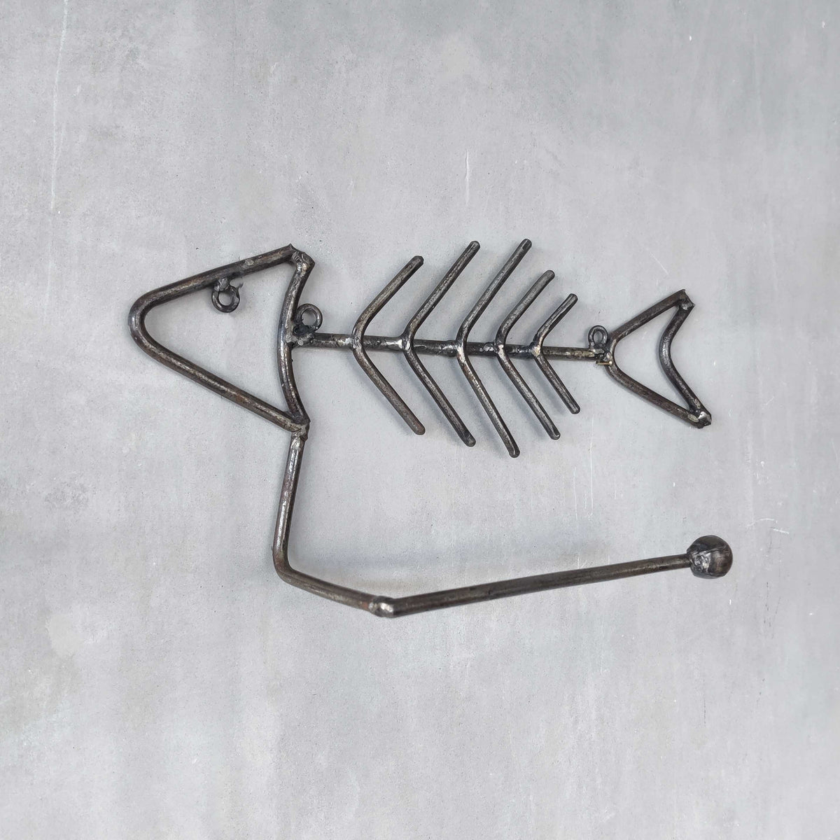 Vintage artisan made metalwork welded steel fish skeleton toilet roll holder