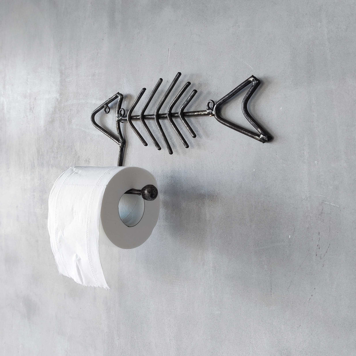 Vintage artisan made metalwork welded steel fish skeleton toilet roll holder