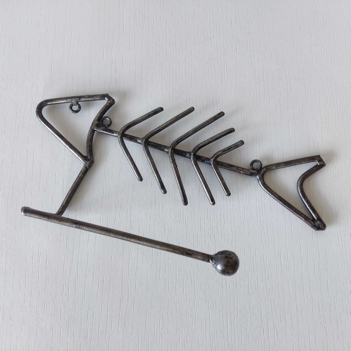 Vintage artisan made metalwork welded steel fish skeleton toilet roll holder