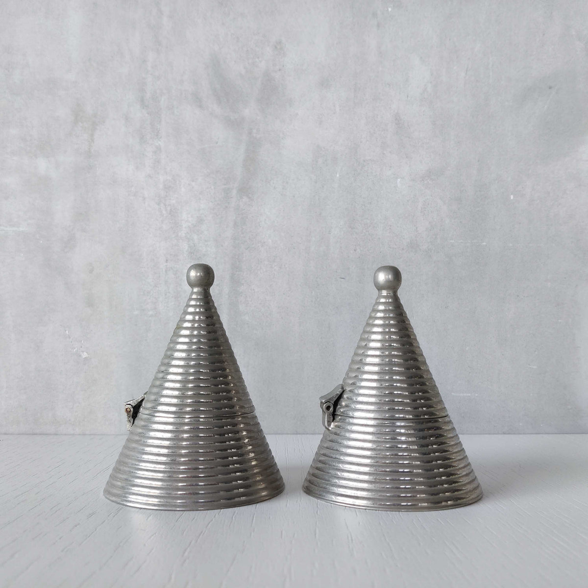 Pair of vintage conical ribbed cast metal tea light holders Aldo Rossi style