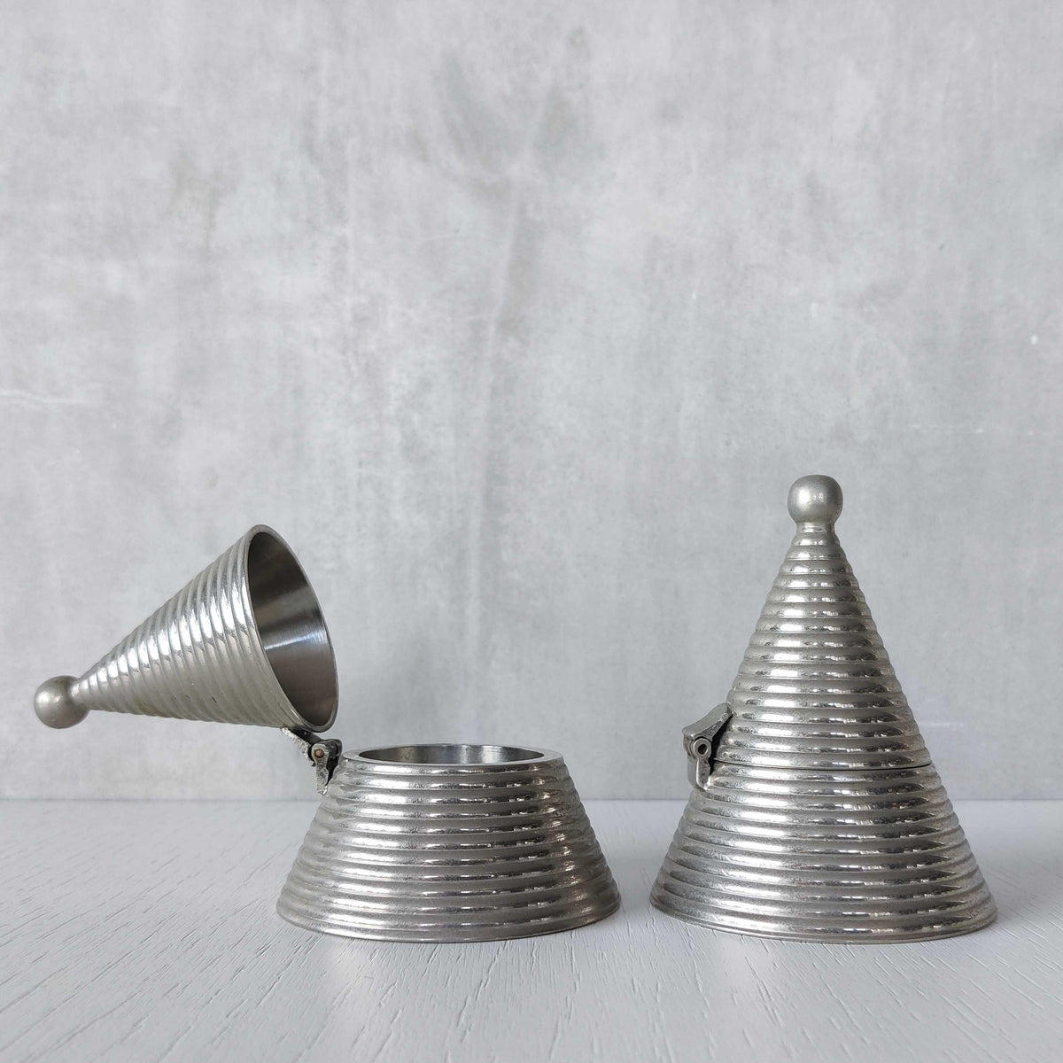 Pair of vintage conical ribbed cast metal tea light holders Aldo Rossi style